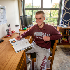 Male Student at Desk in Dorm Room