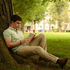 Male Student Reading Under Tree