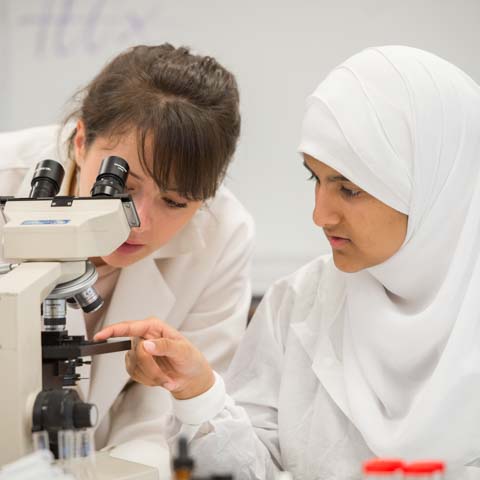 Two female students with microscope - LG