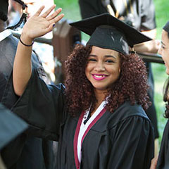 Female Student Waving at Graduation
