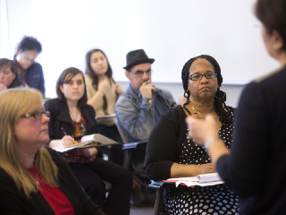 Professor in a classroom with students for a workshop.