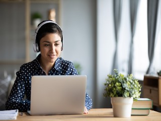 Female working on laptop - Stock photo