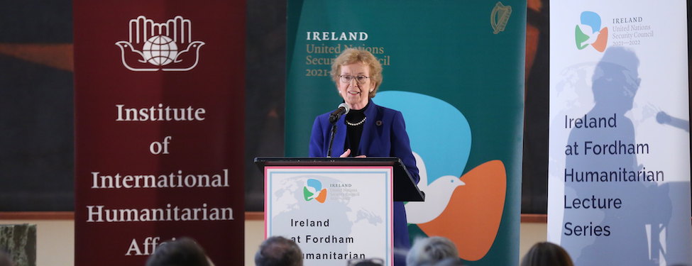 Speaker H.E. Mary Robinson stands at a podium to deliver a speech about the challenges of the humanitarian sector at the United Nations