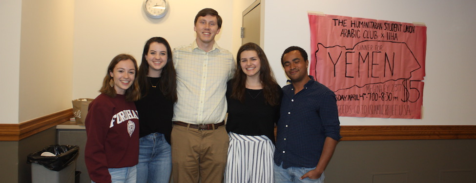 Students standing in from of a sign reading dinner for yemen during a fundraising event for the humanitarian student union