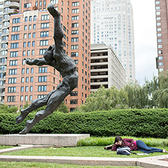 Female student reclining in LC Plaza