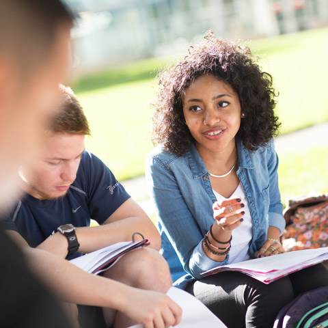 Female and Male Student in Discussion Outdoors