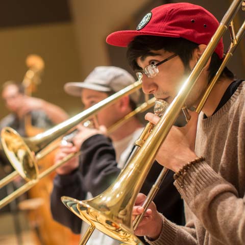 Asian student playing trombone - LG