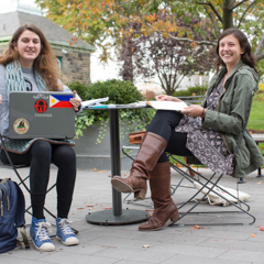 Two Female Students Sitting Outside