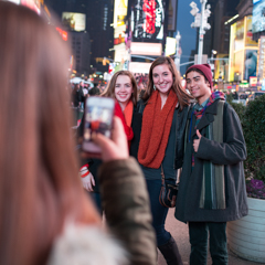 Three Students Getting Photographed in Times Square