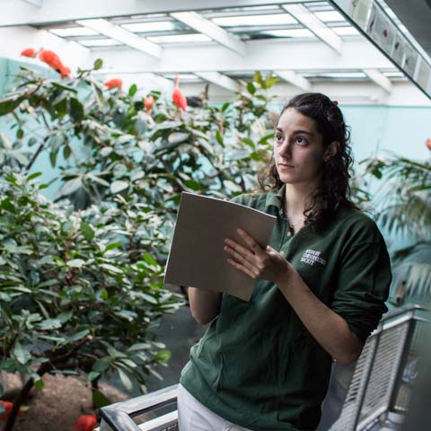 Student with clipboard in greenhouse - LG