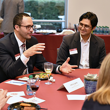 Male President's Council Members Talking at Table