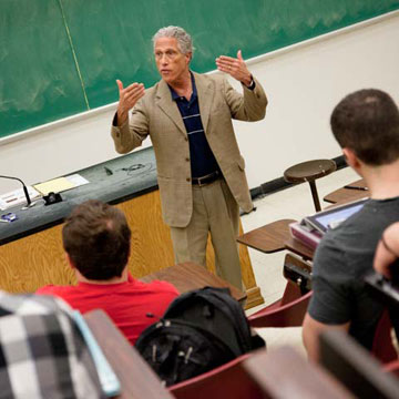 Male professor lecturing in front of classroom