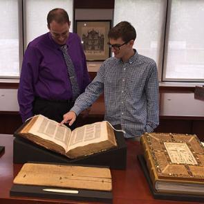 Michael Sanders (Ph.D., History) and David Howes (MA, Medieval Studies; Archives Assistant) present a 15th-century illuminated incunabulum of Justinian's code, and other materials from the University's Special Collections.