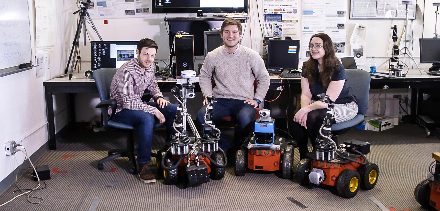 Three Students with Robots