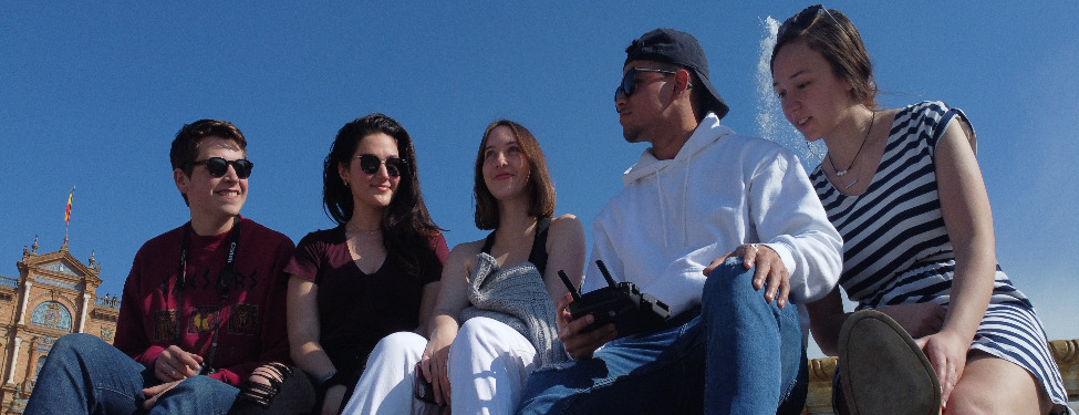 Students sit together on steps in Granada Spain