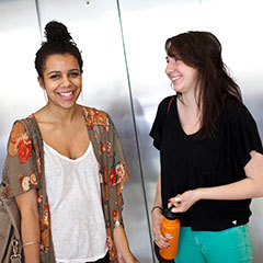 Two female students smiling at camera