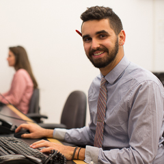 Prof. sitting at computer