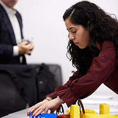 Woman Setting Up Real Estate Model