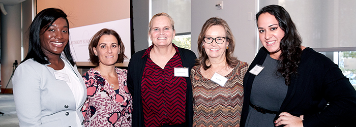 Women smiling for camera at the women's philanthropy summit