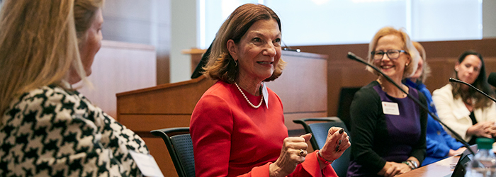 Women talking on a panel at the women's philanthropy summit