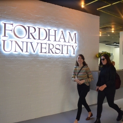 Students stand in front of Fordham sign at London Centre