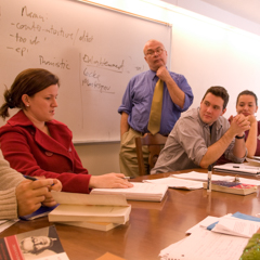 Faculty member in front of white board - SM