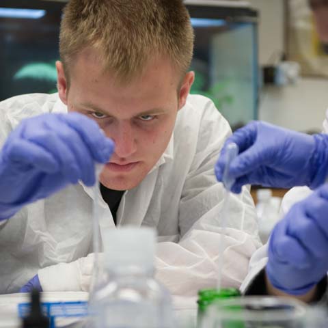 Male student with chem equipment - LG