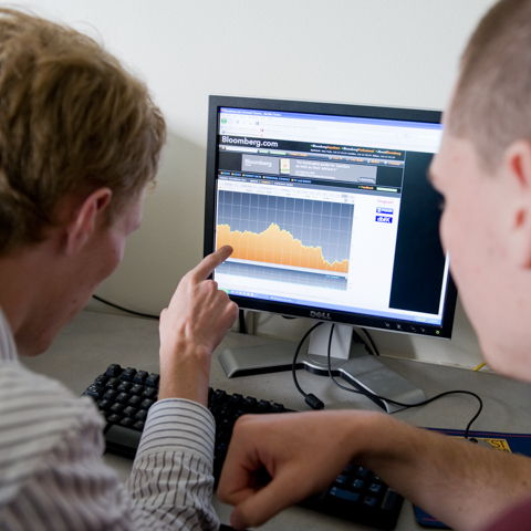 Two students looking at screen with financial data - LG