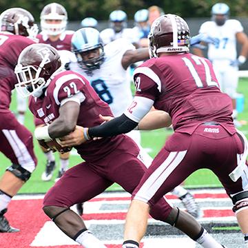 Fordham Football team passes ball during homecoming game.